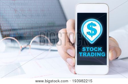 Business man is holding blank screen phone for stock trading
