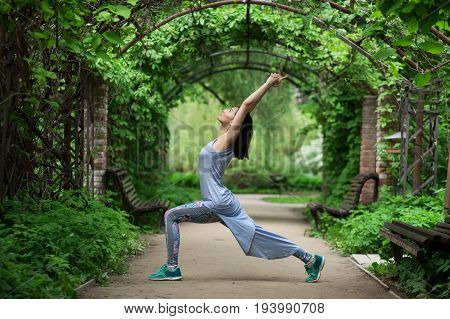 Portrait of woman doing youga in park. Shallow depth of field