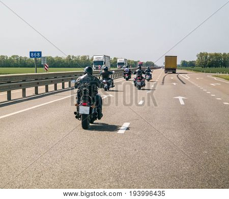 A group of bikers are driving along the highway.