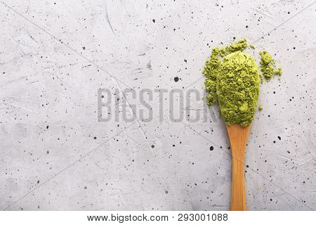 Green Tea Matcha In A Spoon On Concrete Surface. Close Up Shot