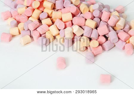 Background From Many Colorful Zephyr. Small Candy Marshmallow Multicolored On White. Sweet Food Fon 