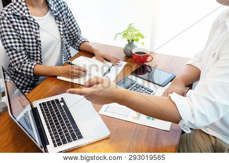 Businessman Point To Laptop  Work With Friend On The Table With Computer Calulator ,working Data Ana
