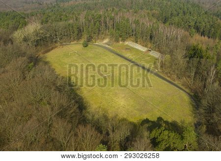 Koszalin, Poland - 30 March 2019 - Aerial View On Grass Ruined Football Stadium Hidden In Deep Fores