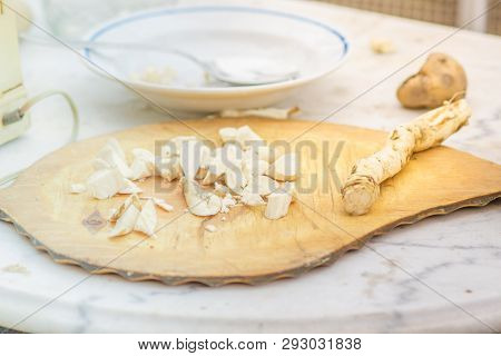 Horseradish Root Sliced On The Board. Table With A Plate