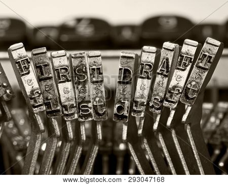 the words   FIRTS DRAFT  with old typwriter keys  monochrome isolated