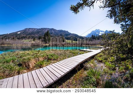 Lake Zelenci, Source Of The Sava Dolinka River, With The Observation Trail Footbridge And Ponce Moun