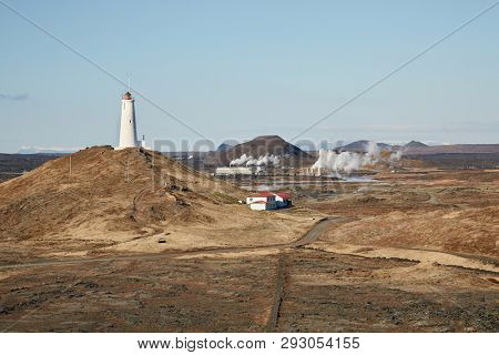 Reykjanes Lighthouse in Iceland with Gunnuhver geotermal area in the background