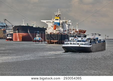 Ship traffic in the busy Port of Rotterdam, large crude oil tanker ship coming into port