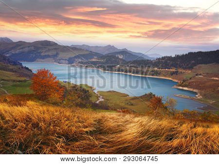 Mountains And Lake Roselend  With A Dike