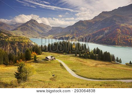 Mountains And Lake Roselend  With A Dike