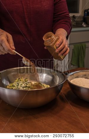 Sprinkling Cinimon From A Plastic Measuring Spoon