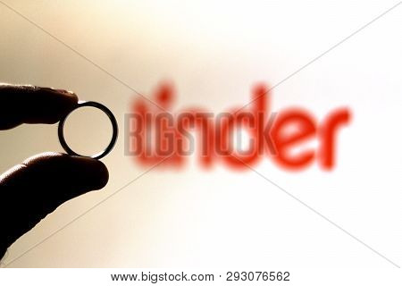 April 2, 2019, Brazil. Man Safe Wedding Ring. Tinder Logo In The Background. People Use Tinder For R