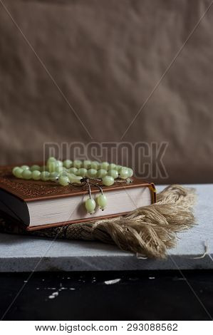 The Holy Quran With Rosary And Praying Carpet. Image Of The Holy Quran With Rosary. Muslim Rosary Be