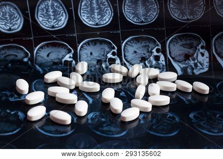 White Pharmaceutical Medicine Pills On Magnetic Brain Resonance Scan Mri Background. Pharmacy Theme,