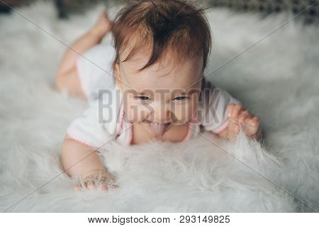 Portrait Of A Newborn Baby With His Tongue Sticking Out