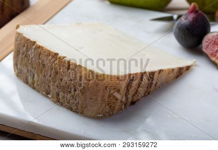 Piece Of French Cheese Tomme De Brebis Made From Sheep Milk Served As Dessert With Fresh Figs And Pe