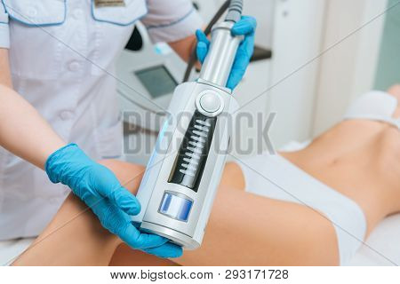 Cropped View Of Cosmetologist Doing Endospheres Therapy For Leg