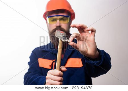 Repair Service. Builder, Worker In Hard Hat Clogs Small Nail. Repairman Using Hammer Clogs Nail. Bea