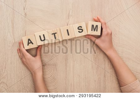 Cropped View Of Woman Holding Wooden Cubes With Autism Lettering