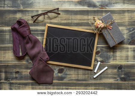 Flat Lay Image Of Gift Box, Necktie, Glasses And Blank Space Chalkboard. Father's Day, Valentine's D