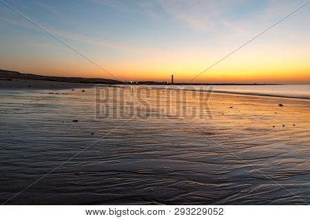 Dusk Shot At Shivrajpur Beach Gujarat India With Cloudy Sky And Reflection In Waves