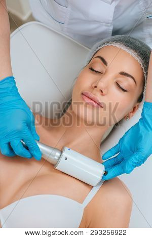 Partial View Of Cosmetologist In Rubber Gloves Doing Endospheres Therapy For Chest