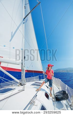 Little Boy On Board Of Sailing Yacht On Summer Cruise. Travel Adventure, Yachting With Child On Fami
