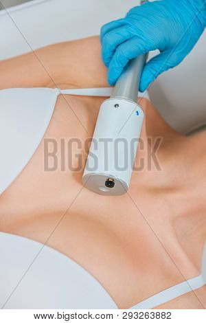 Partial View Of Cosmetologist In Rubber Gloves Doing Endospheres Therapy For Chest