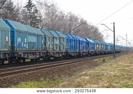 Long Freight Train. All Wagons In Shades Of Blue.