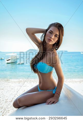 Sexy Woman Wearing Blue Swimwear On The Beach