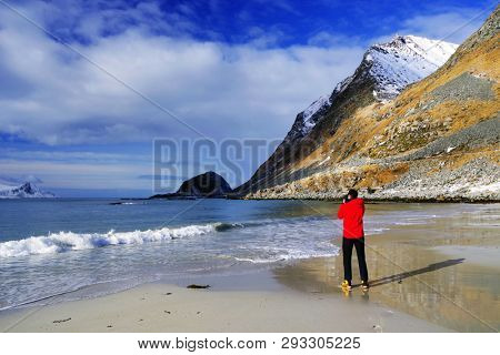 Landscape photographer on Haukland Beach in Lofoten Archipelago, Norway, Europe