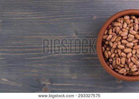 A Plate Of Beans On Wooden Table Background