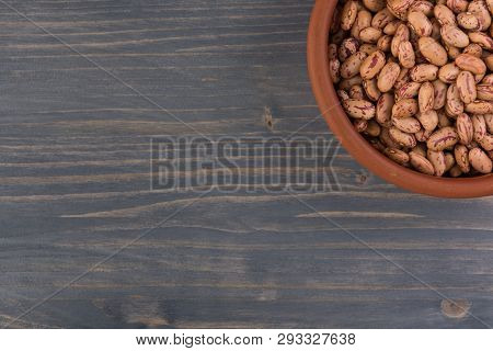 A Plate Of Beans On Wooden Table Background