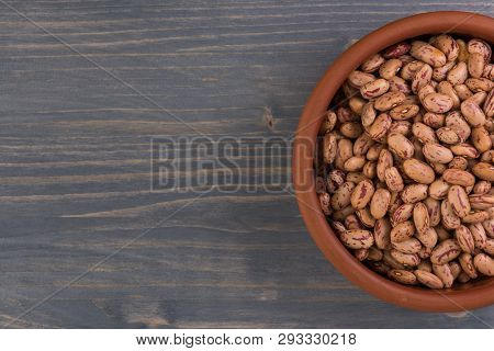A Plate Of Beans On Wooden Table Background