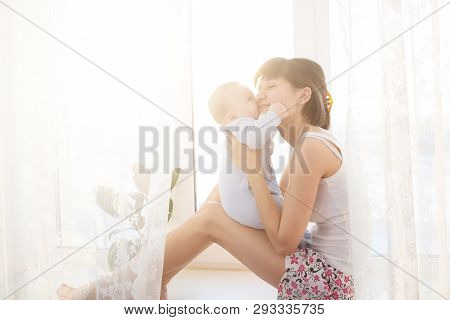 Little Baby In The Arms Of Her Mother Living Room.