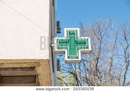Pharmacy Sign, Green Cross Pharmacy Sign Or Symbol On The Building Facade View From The Street