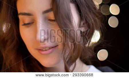 Closeup Shoot Of Young Attractive Caucasian Female Smiling Seductively In Front Of The Camera With B
