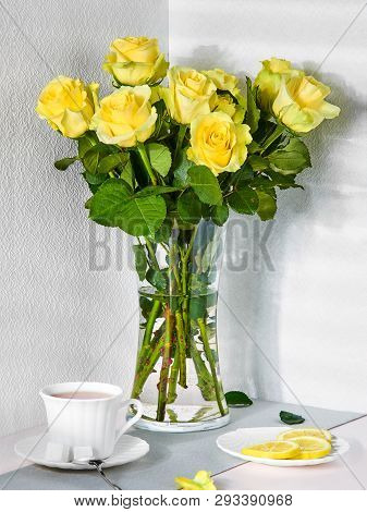 Breakfast With A Bouquet Of Yellow Roses, A Cup Of Tea And Lemon In The Morning Light