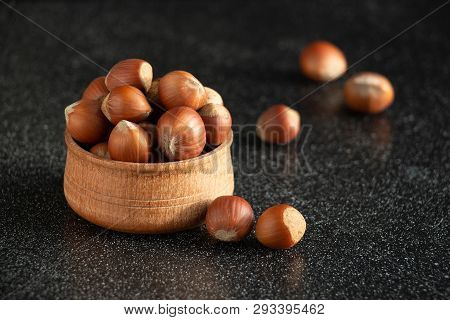 Сlose-up Of Nuts On A Wooden Plate In Warm Tones