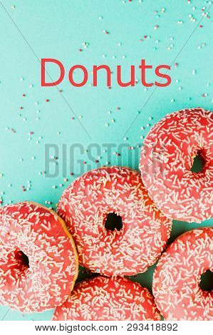 Donuts Decorated With Icing On Blue Background.