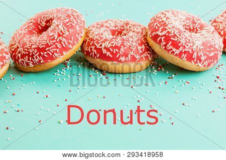 Donuts Decorated With Icing On Blue Background.