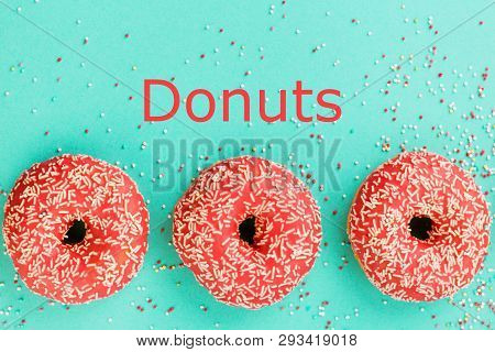 Donuts Decorated With Icing On Blue Background.
