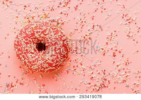Coral Donut Lying On Pink. Donut Decorated With Icing On Pink.