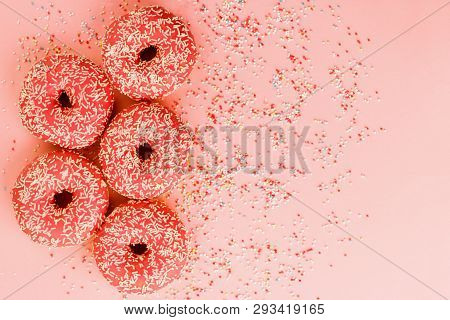Five Coral Donuts Lying In A Line.