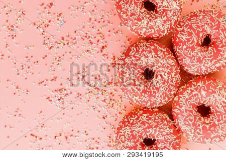 Five Coral Donuts Lying In A Line.