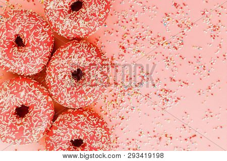 Five Coral Donuts Lying In A Line.
