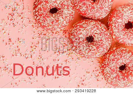 Five Coral Donuts Lying In A Corner.