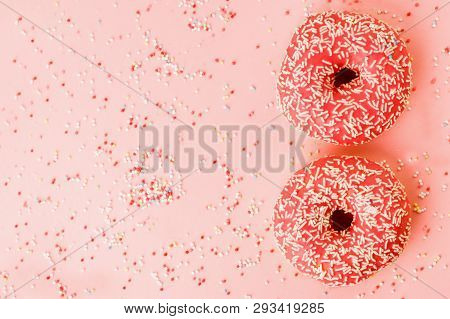 Two Coral Donuts. Donuts With Icing On Pink Background.