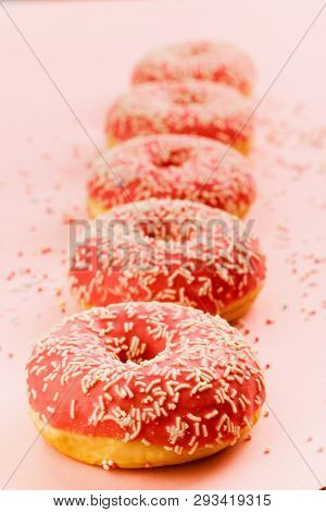 Five Coral Donuts Standing In A Line. Donuts With Icing