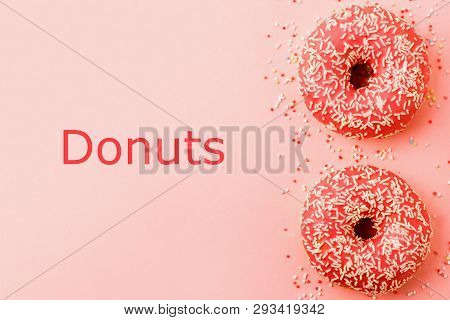 Two Coral Donuts. Donuts With Icing On Pink Background.